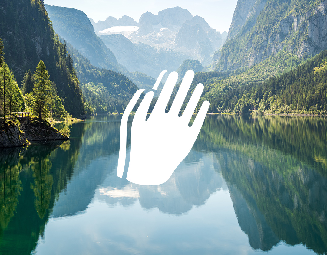 Mountain lake with praying hands icon