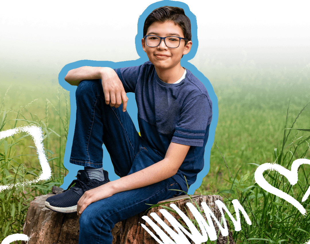 Kid sitting on rock