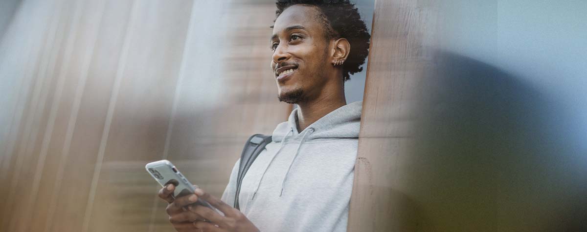 Person smiling and using a phone